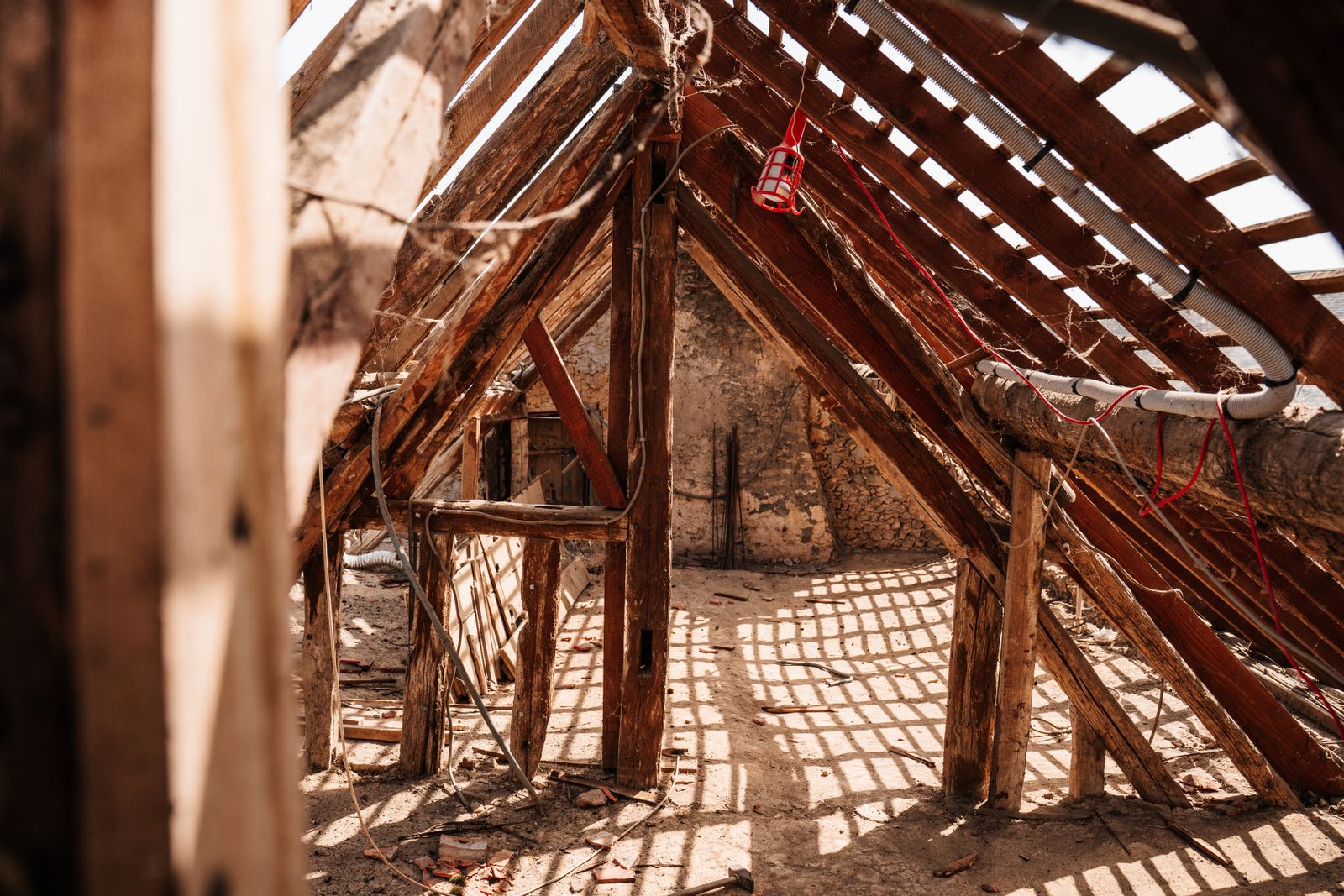 The same attic before air sealing, with open top plates and bare framing